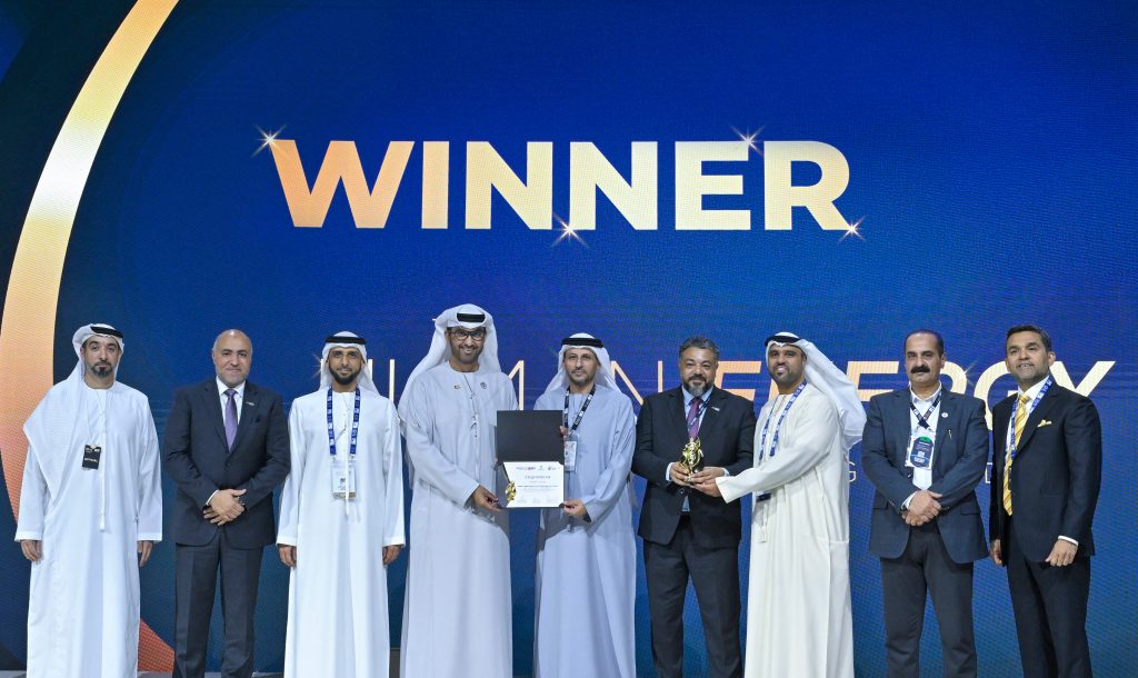 HE Dr. Sultan Al Jaber presents the award to NMDC Group, which won the Highly Commended category.